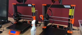 two 3D printers on a table