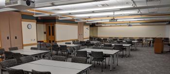 Andersen Library room 120 with tables in rectangle pod set up with chairs
