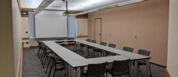 Andersen Library room 120A with tables set in a rectangle with chairs