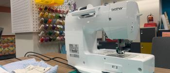 Sewing machine, cutting mat, sewing supplies, and colorful thread