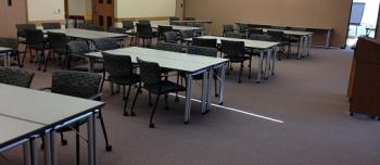 tables and chairs set up in pod configuration in Andersen Library room 120
