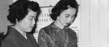 An archival photo of two Japanese women preparing dinner for a Japanese-American family club. 