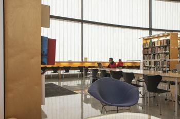 Large library space with soft seating, tables, and chairs
