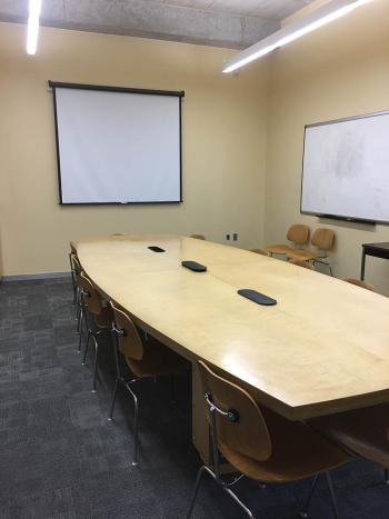 Large conference room with projection screen and whiteboard
