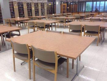 Many tables and chairs in library