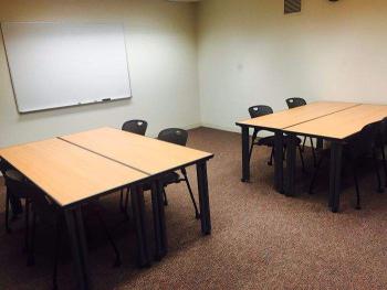 Room with tables, chairs and whiteboard