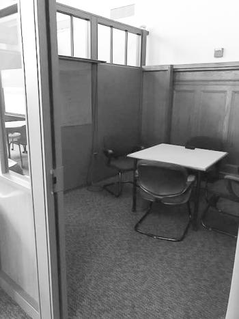 Table with chairs inside study room with partial height walls