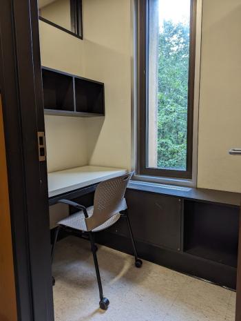 Reservable study room with window. Partially enclosed.