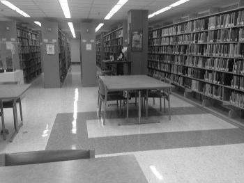 Library stacks with tables and chairs